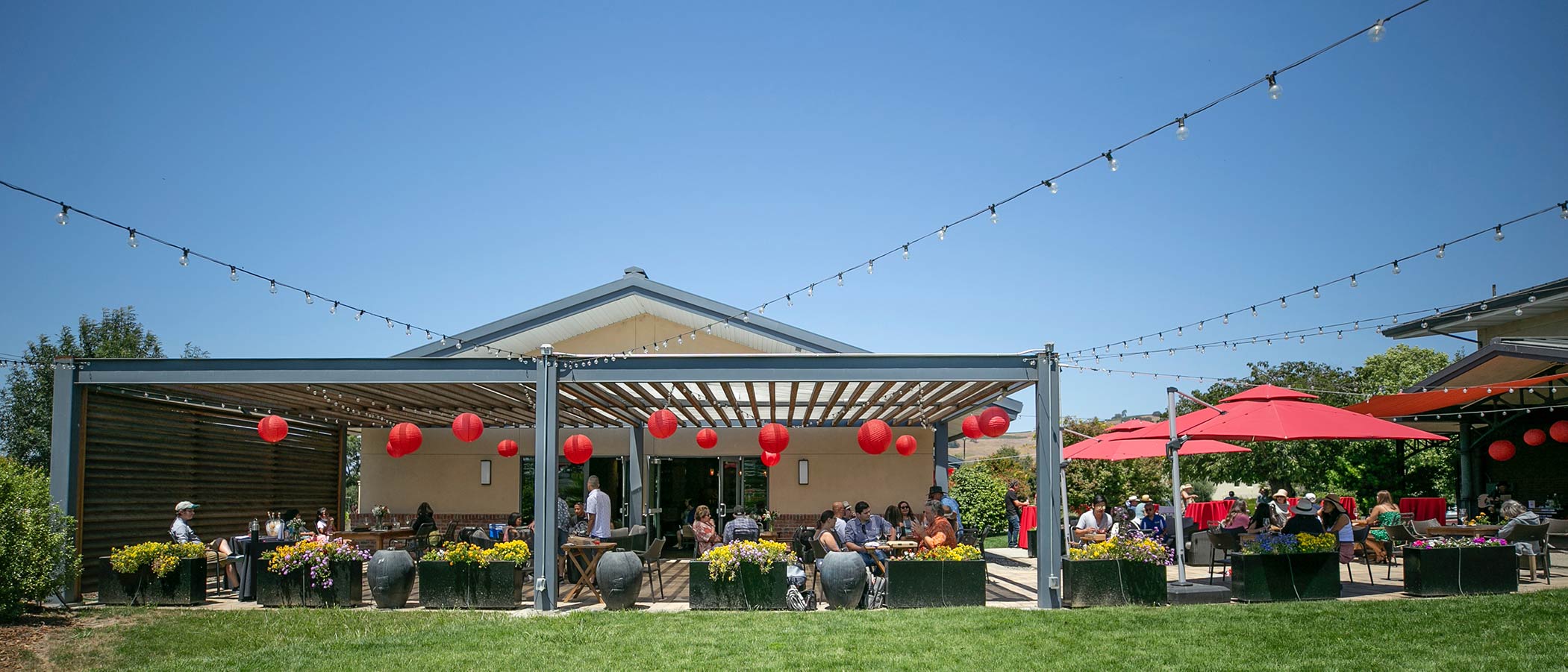 Festival guests on the patio enjoy the celebration.