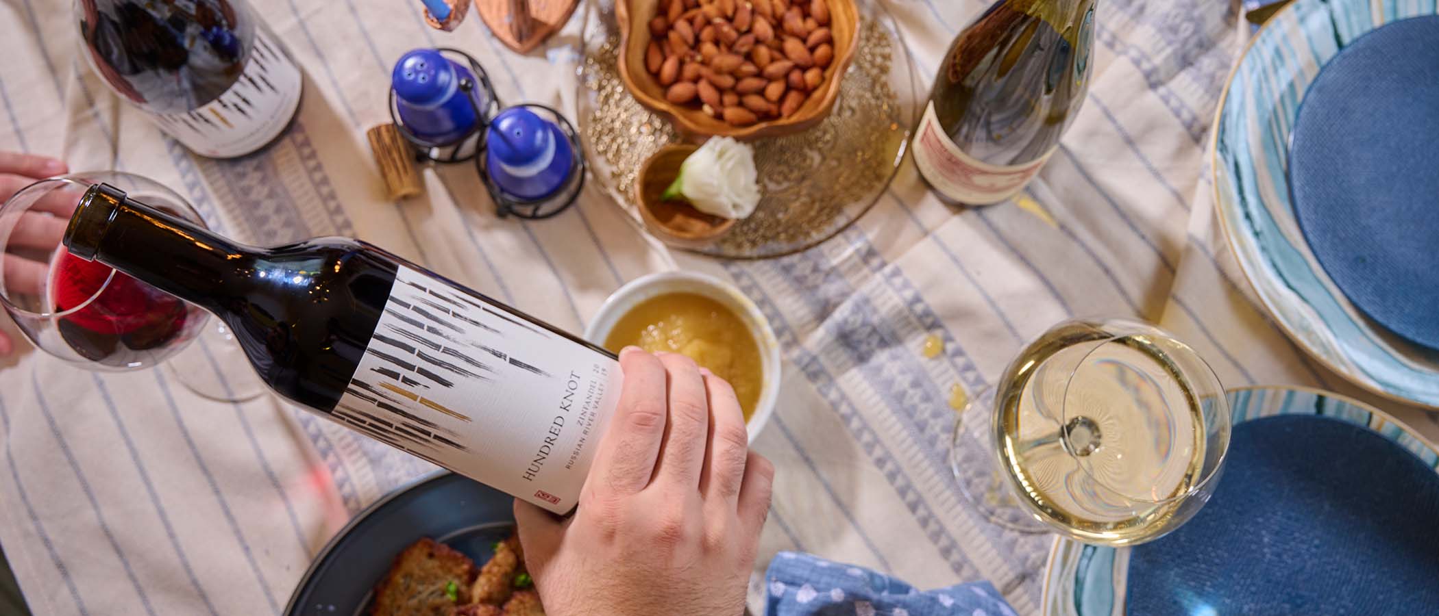 Pouring wine at a Hanukkah dinner table