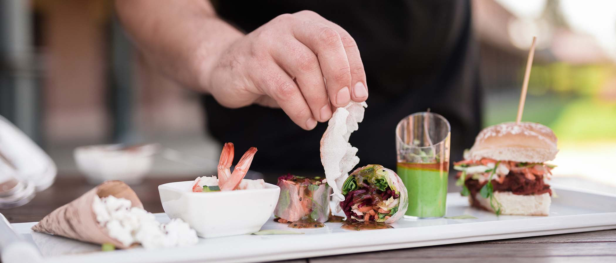 Hand placing food on tray