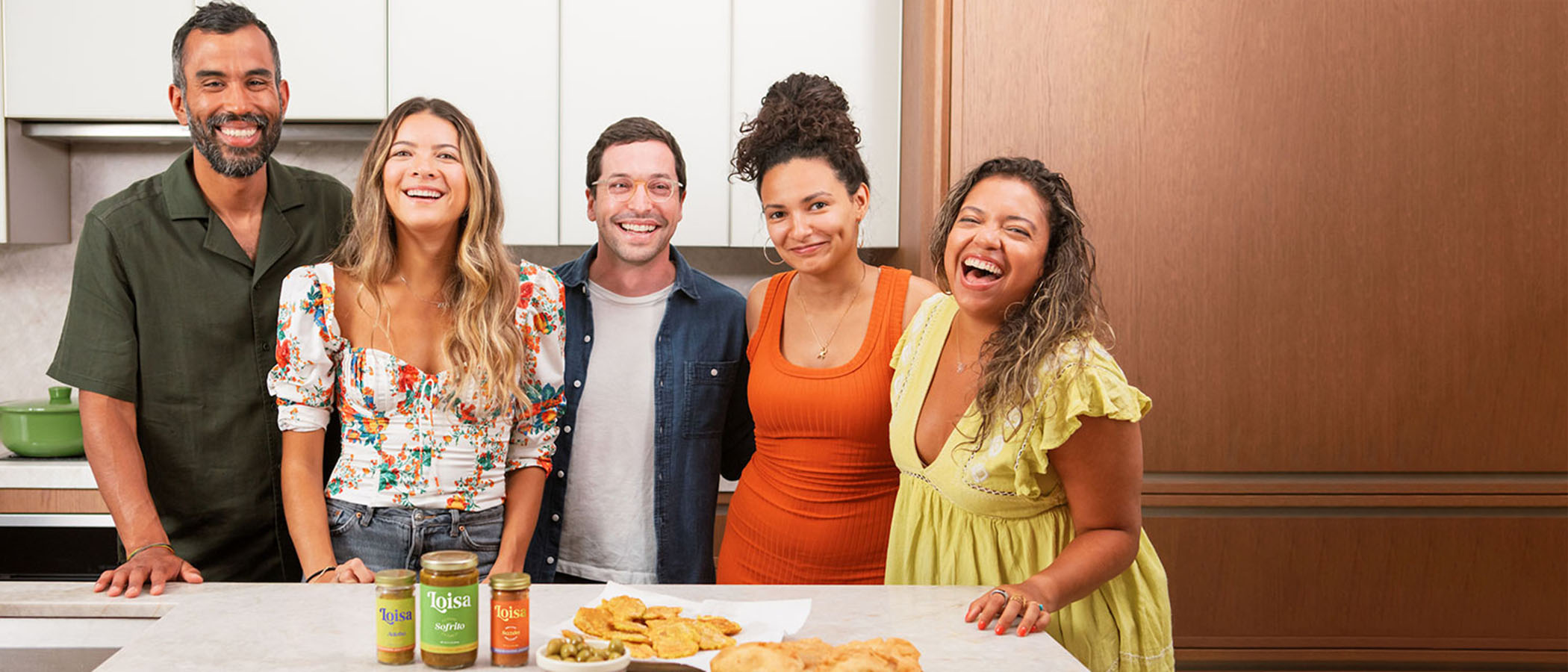 Five people in front of kitchen counter