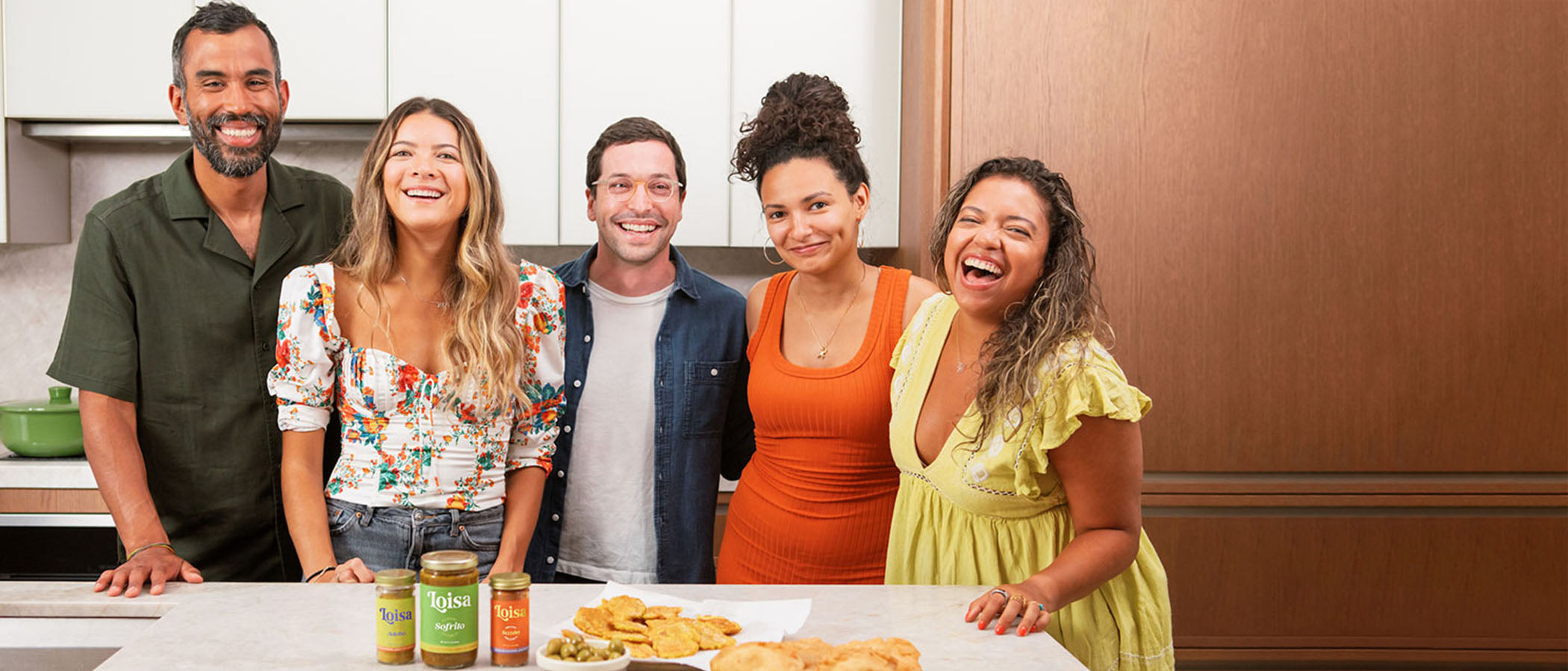 Five people in front of kitchen counter