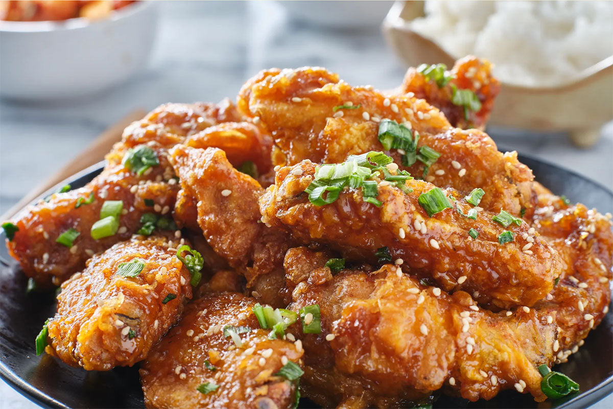 Pile of sauced wings on a plate