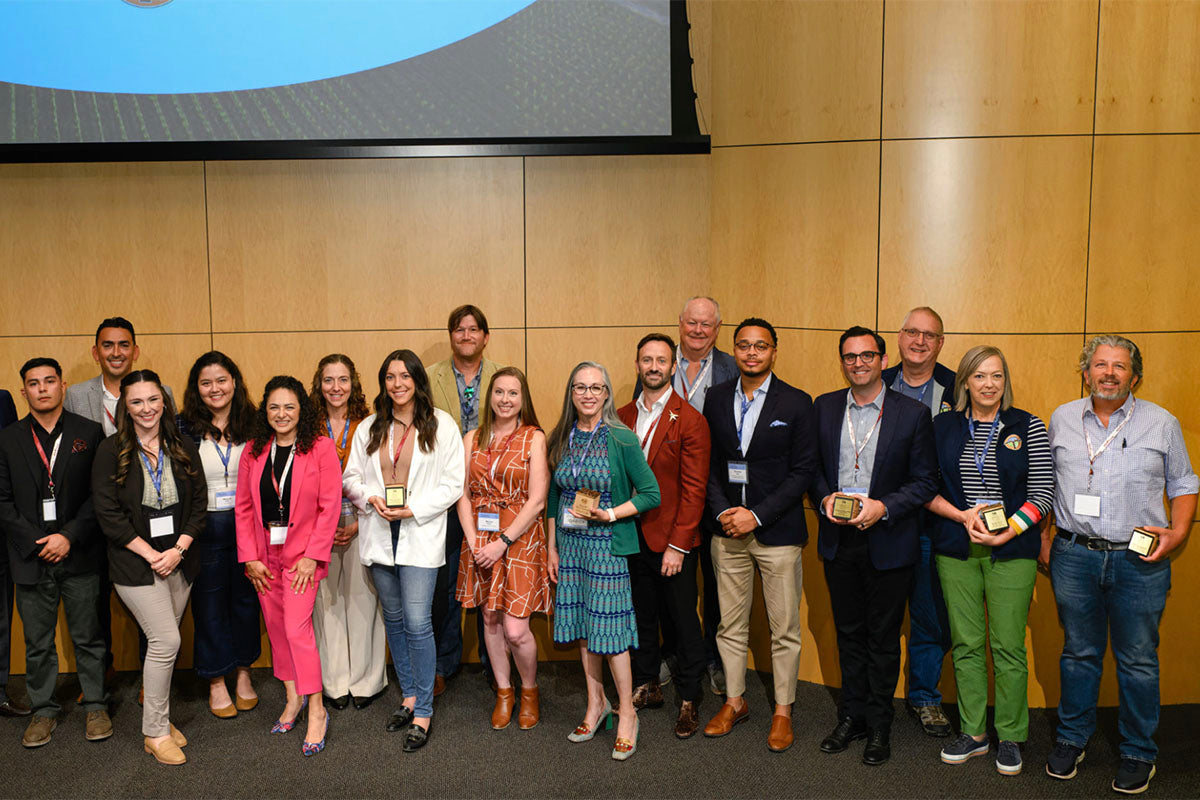 Large group of people posing for award ceremony photo