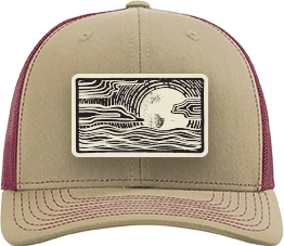 A tan and burgundy trucker cap featuring a rectangular front patch with a black and white wave pattern and a central white circle.