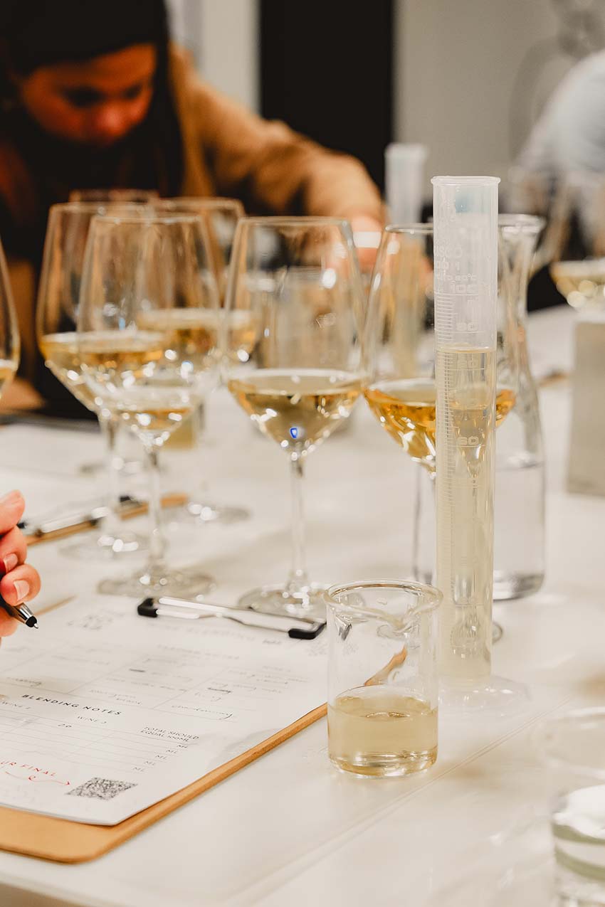 Blending white wine with glasses and a graduated cylinder