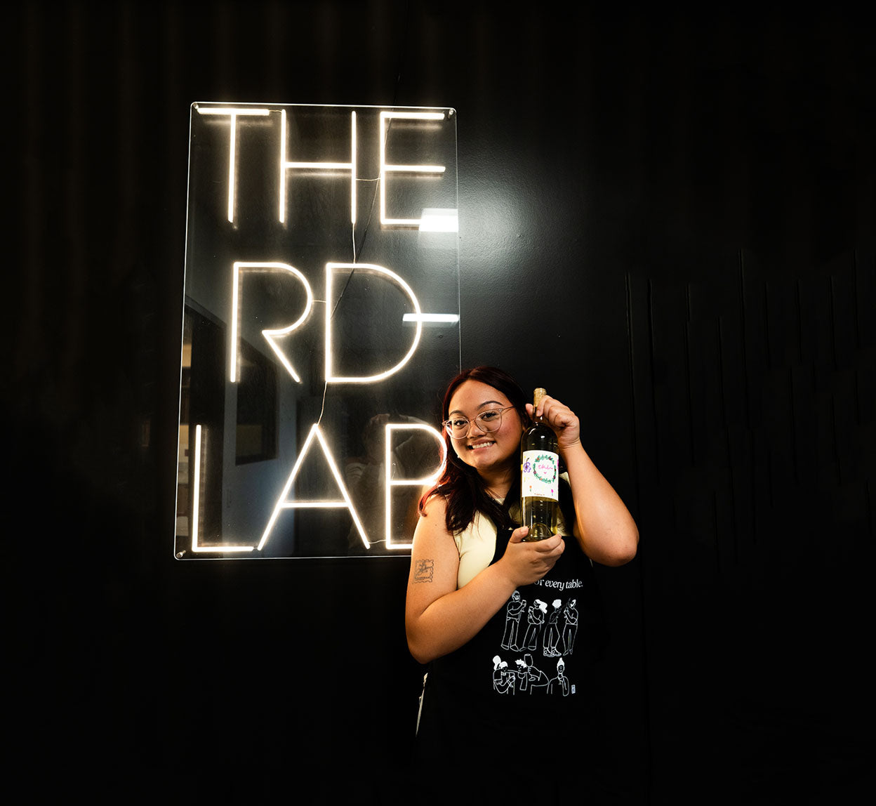 A woman holding a custom blend bottle of wine