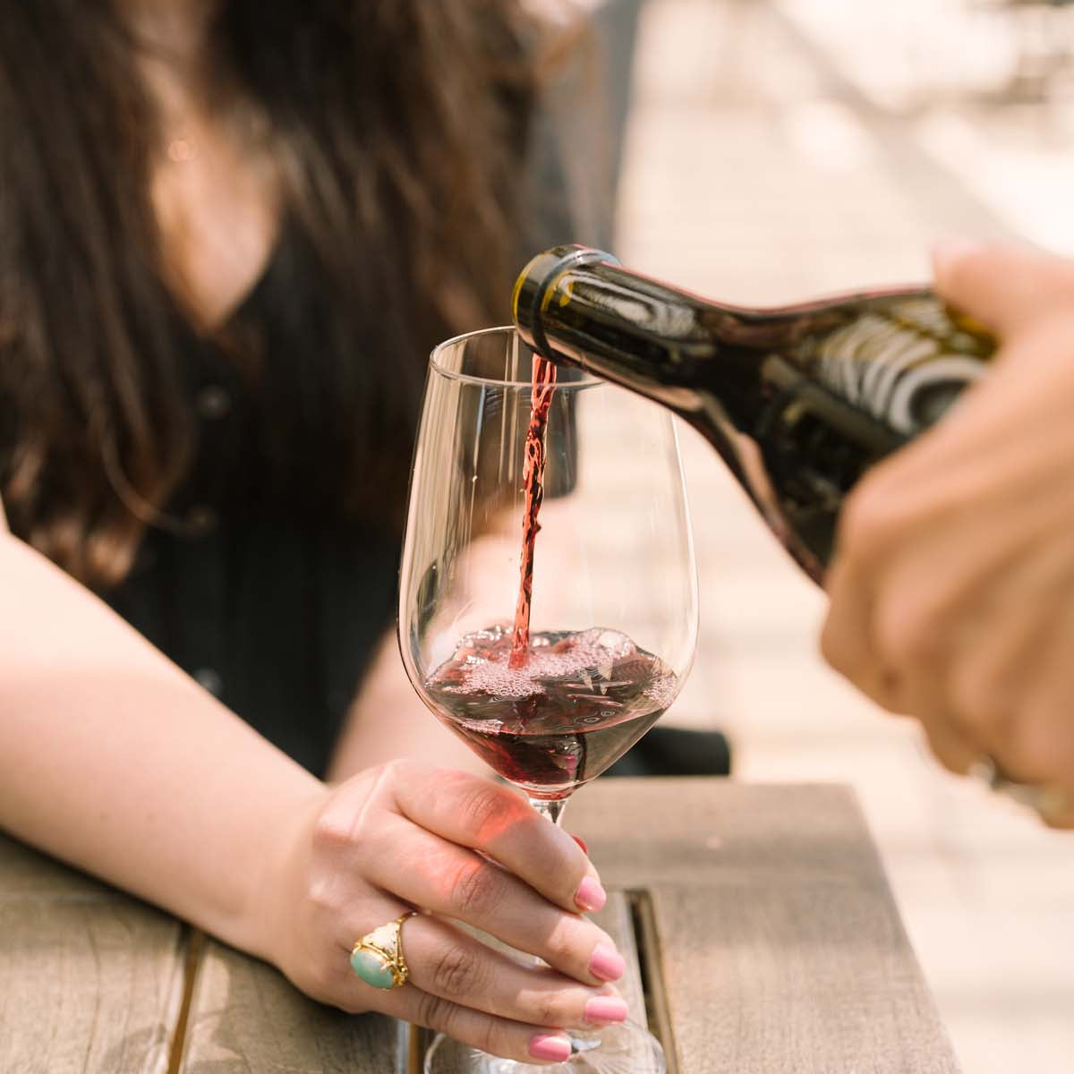 pouring red wine into glass