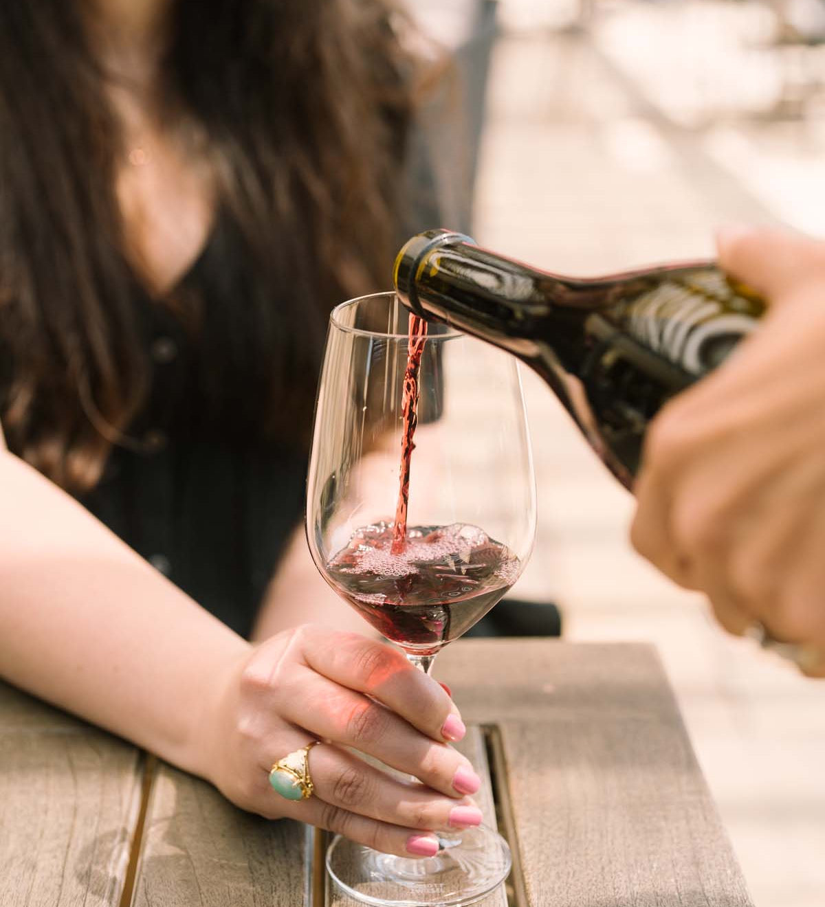 pouring red wine into glass