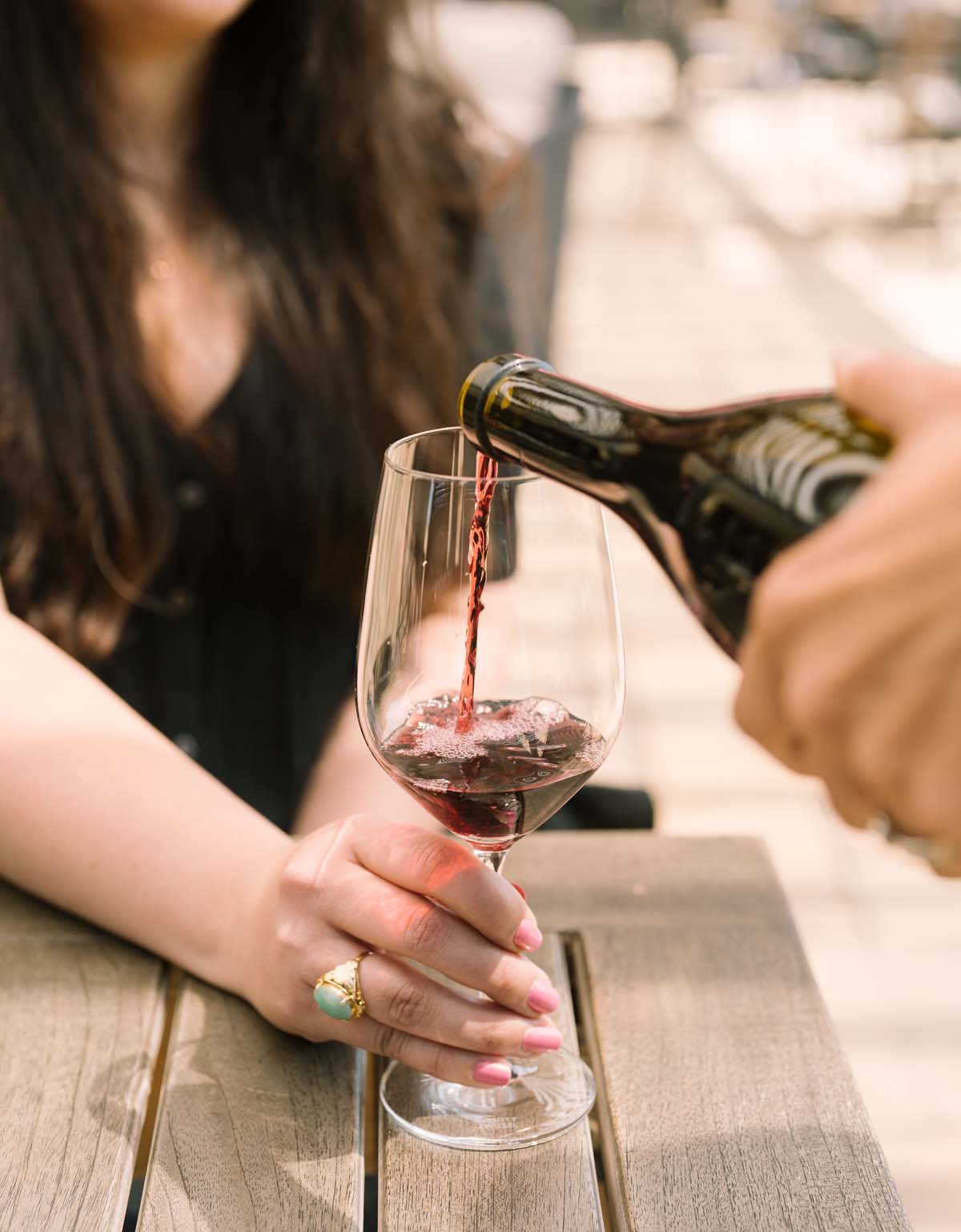 pouring red wine into glass