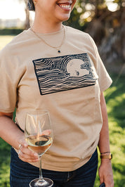Close up of woman in khaki colored logo t-shirt