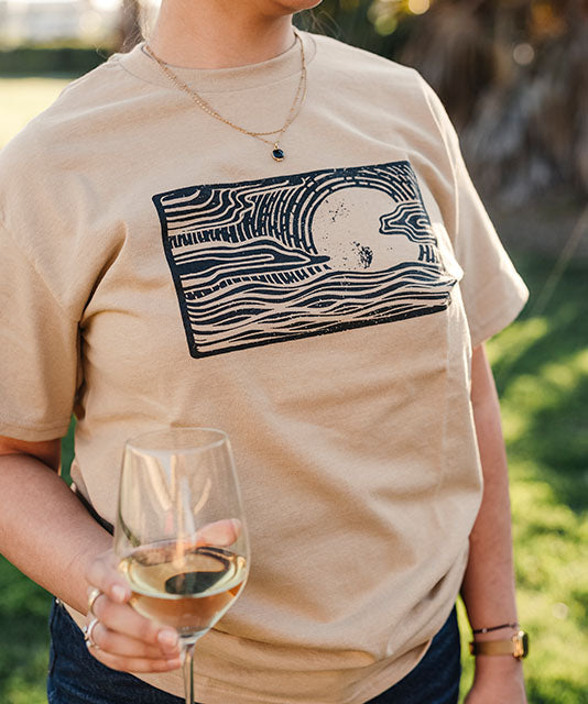 Close up of woman in khaki colored logo t-shirt