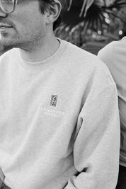 black and white image of man in logo crew neck sweatshirt