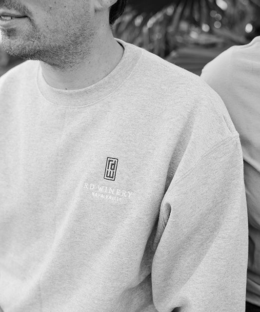 black and white image of man in logo crew neck sweatshirt