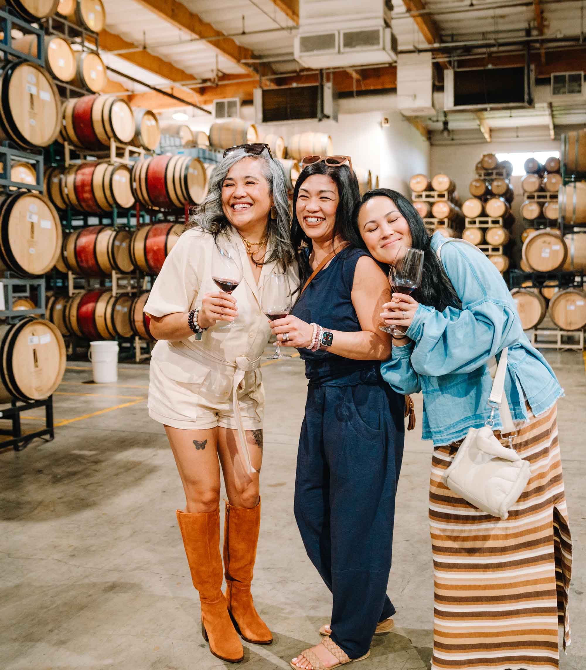 Women tasting wine in a Napa winery barrel room