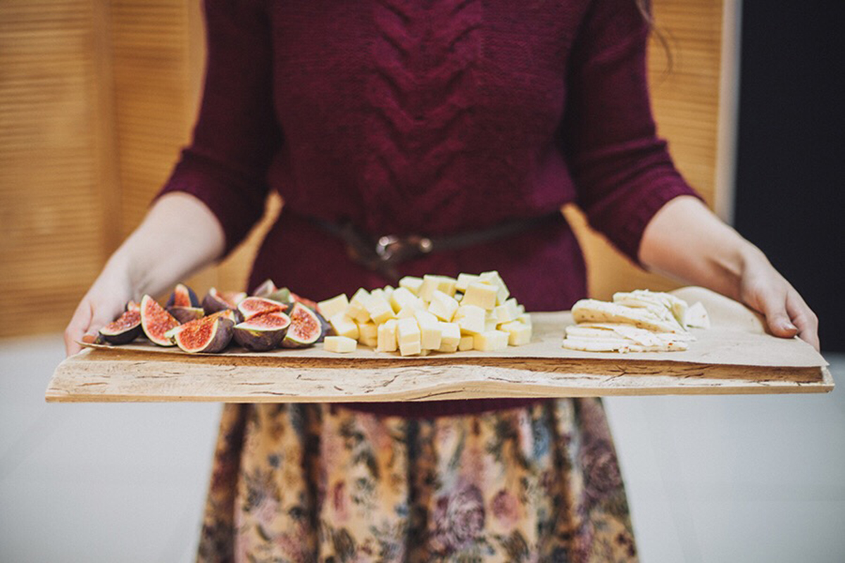 Woman serving a cheese platter