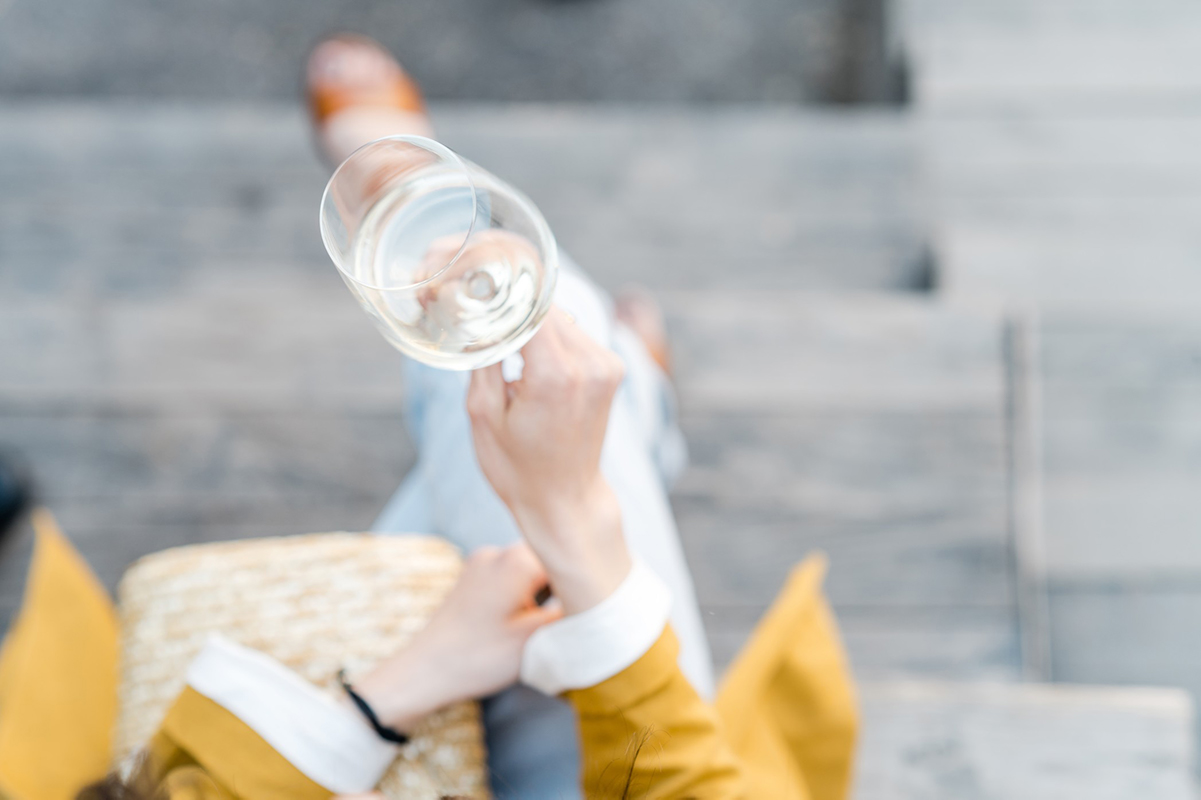 Woman enjoying a glass of Sauvignon blanc outdoors