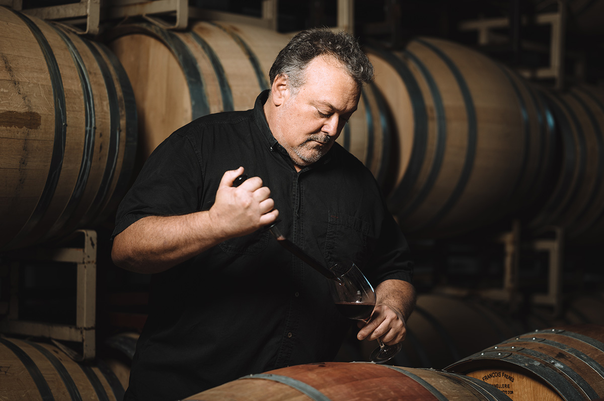 Winemaker Timothy Milos sampling wine
