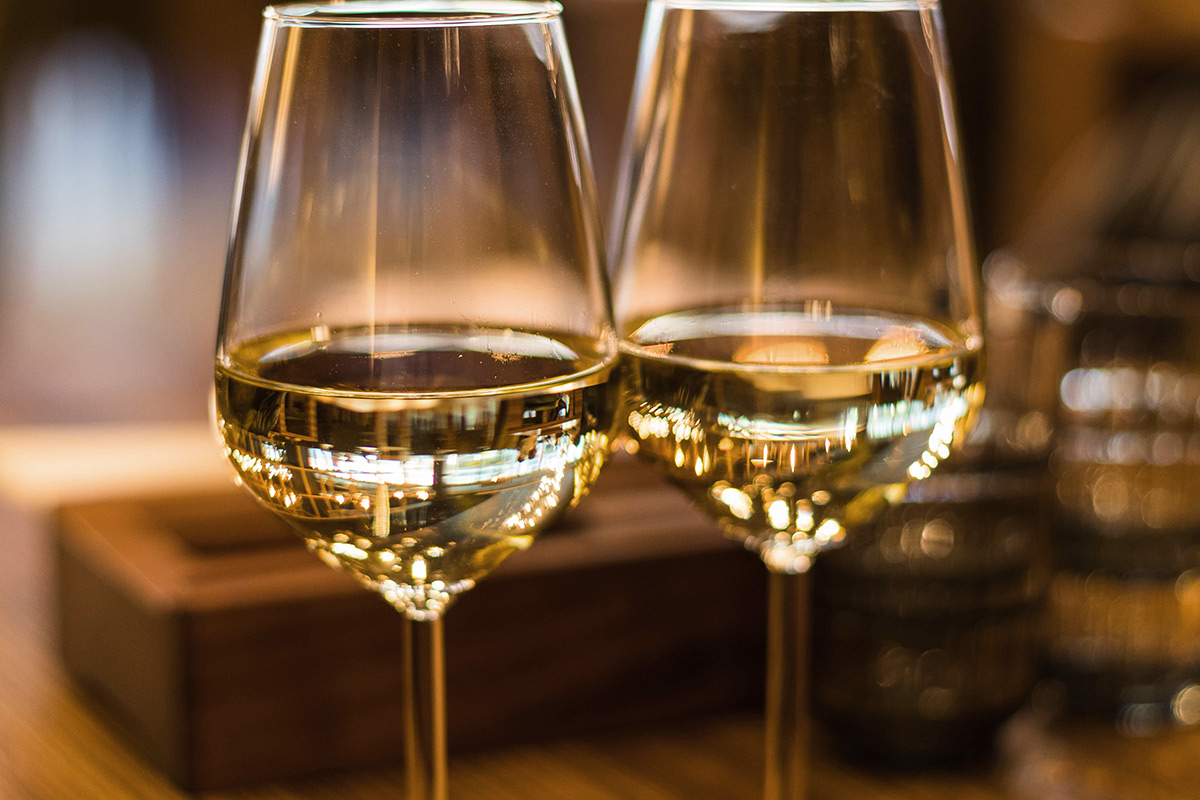 Two white wine glasses close up