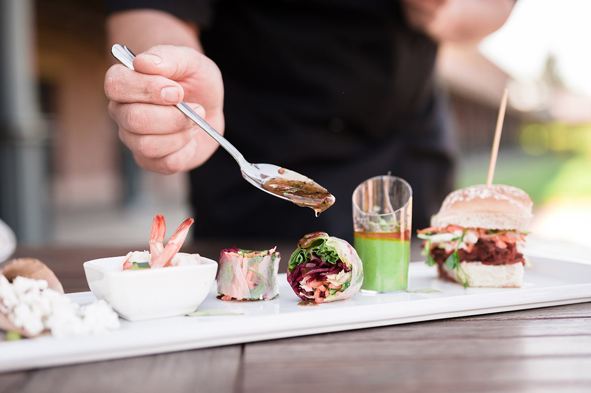 chef pouring sauce onto a spring roll