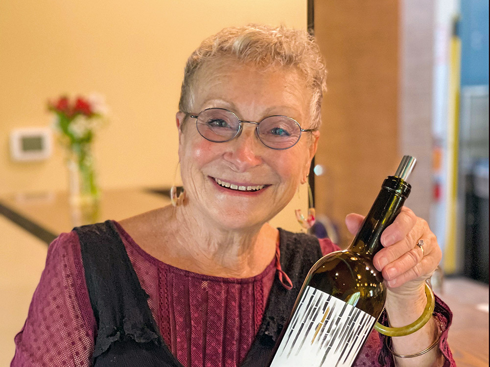 Photo of woman holding a bottle of wine