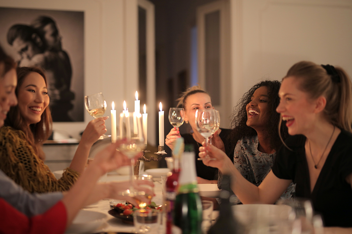 A group of friends toasting at the table.