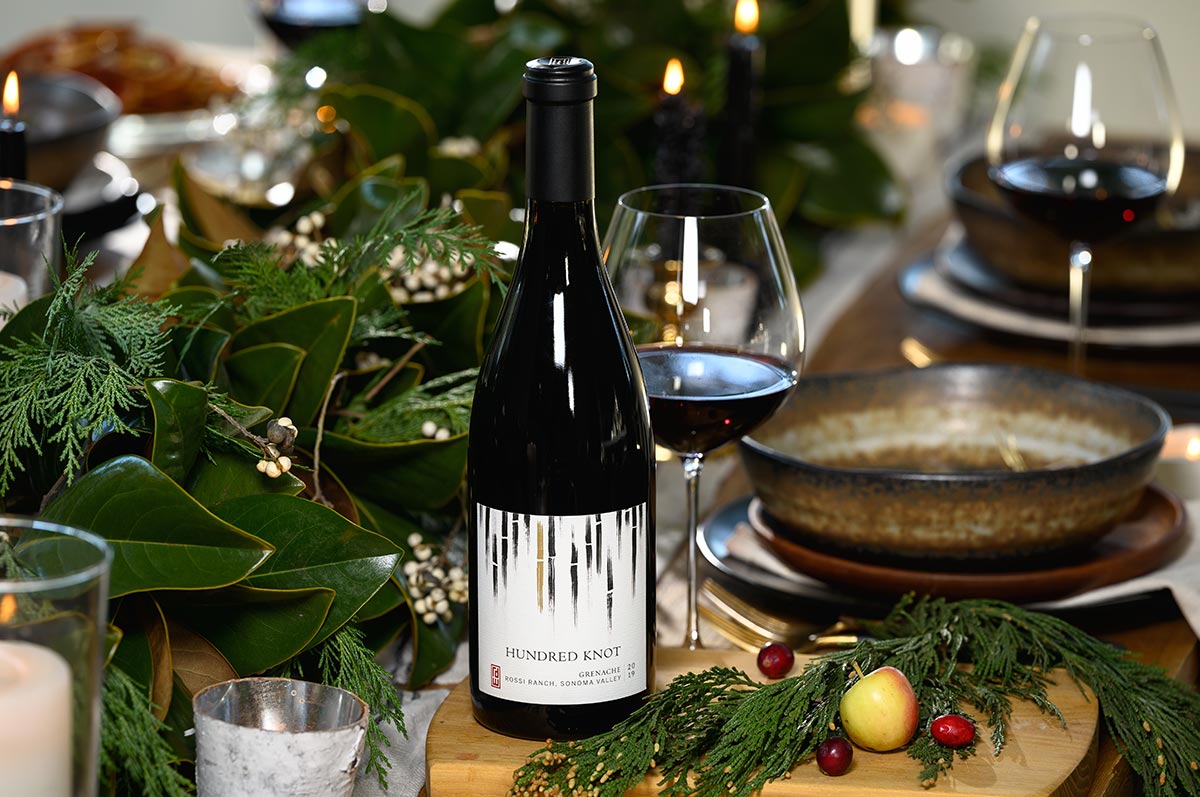 A bottle of red wine on a holiday table.
