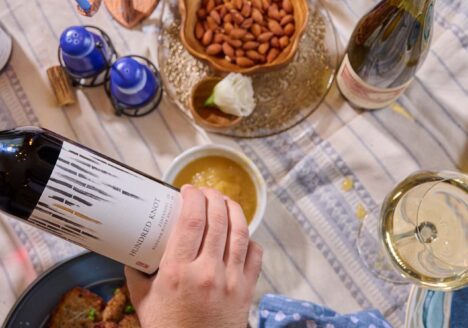 Pouring wine at a Hanukkah dinner table