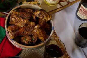 Jerk chicken in a bowl with red wine for Kwanzaa.