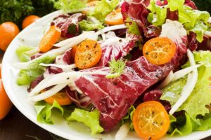 Colorful salad with kumquats