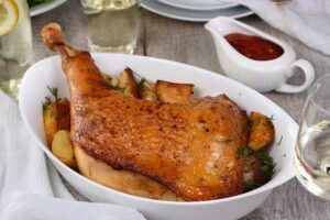 Roasted turkey leg on vegetables