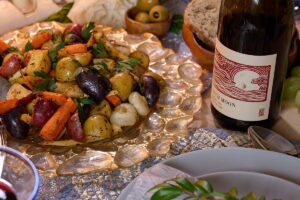 Roasted root vegetables with wine on a yule table