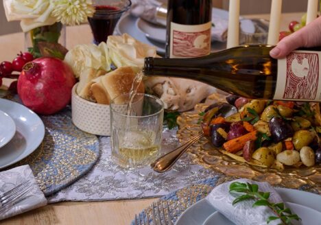 Pouring a glass of wine at Winter Solstice dinner table