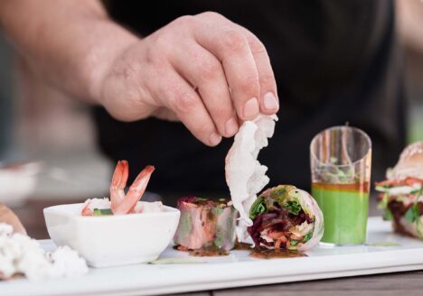 Hand placing food on tray