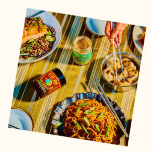 Colorful table filled with Asian dishes made with Fly By Jing products