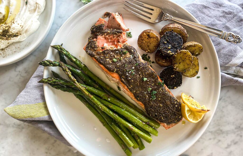 A plate of salmon, asparagus, and roasted potatoes