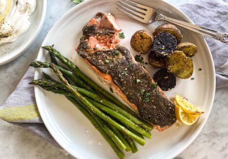 A plate of salmon, asparagus, and roasted potatoes