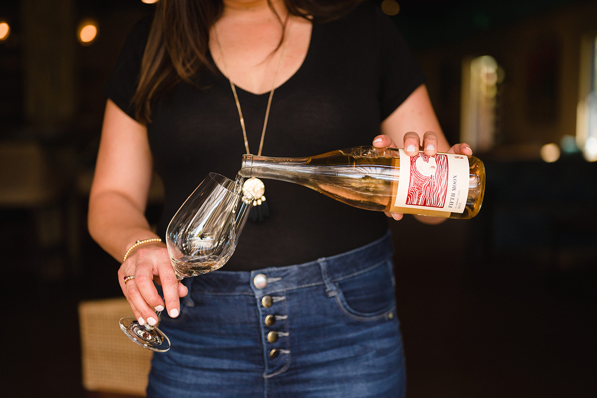 Woman in black shirt pouring rosé