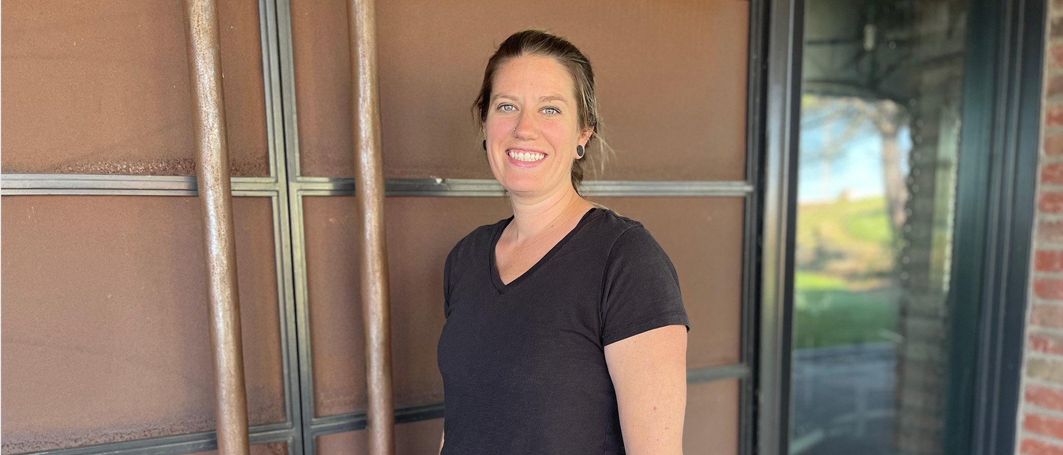 Assistant Winemaker Rachael Froehlich in front of cellar doors