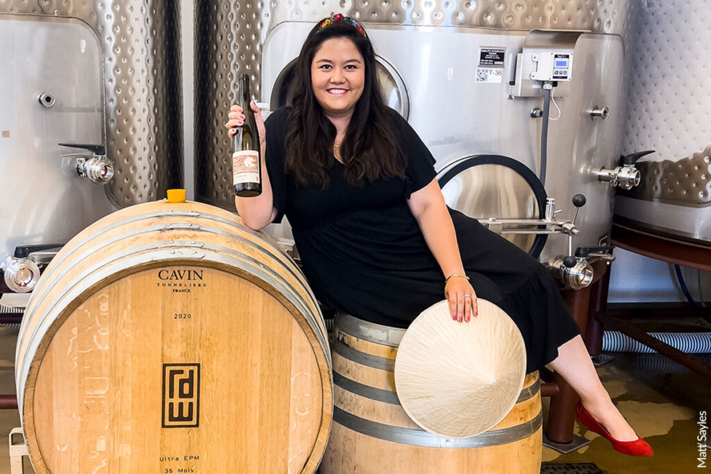 Mailynh Phan portrait posing on wine barrels
