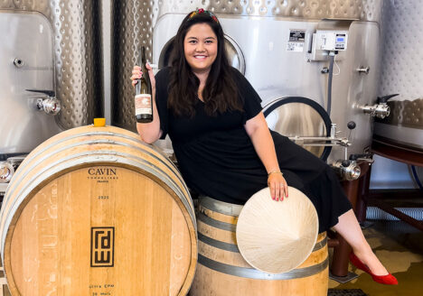 Mailynh Phan portrait posing on wine barrels