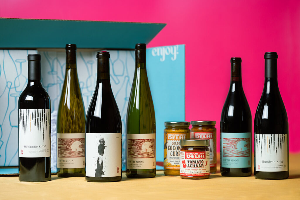 Seasonal Foodie box items featuring six wines and Brooklyn Delhi sauces