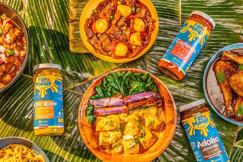 Colorful Filipino food on a table with jarred sauces