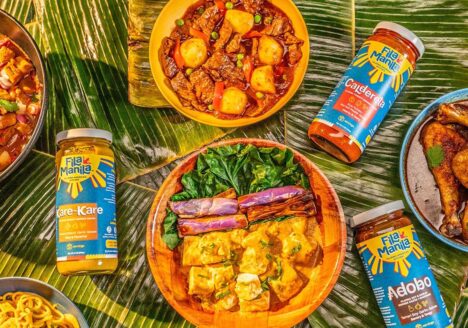 Colorful Filipino food on a table with jarred sauces