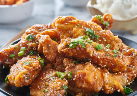 Pile of sauced wings on a plate