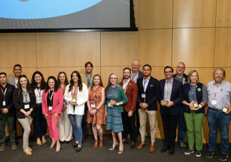 Large group of people posing for award ceremony photo