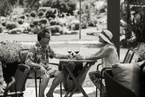 Winery guest couple sitting at outdoor table