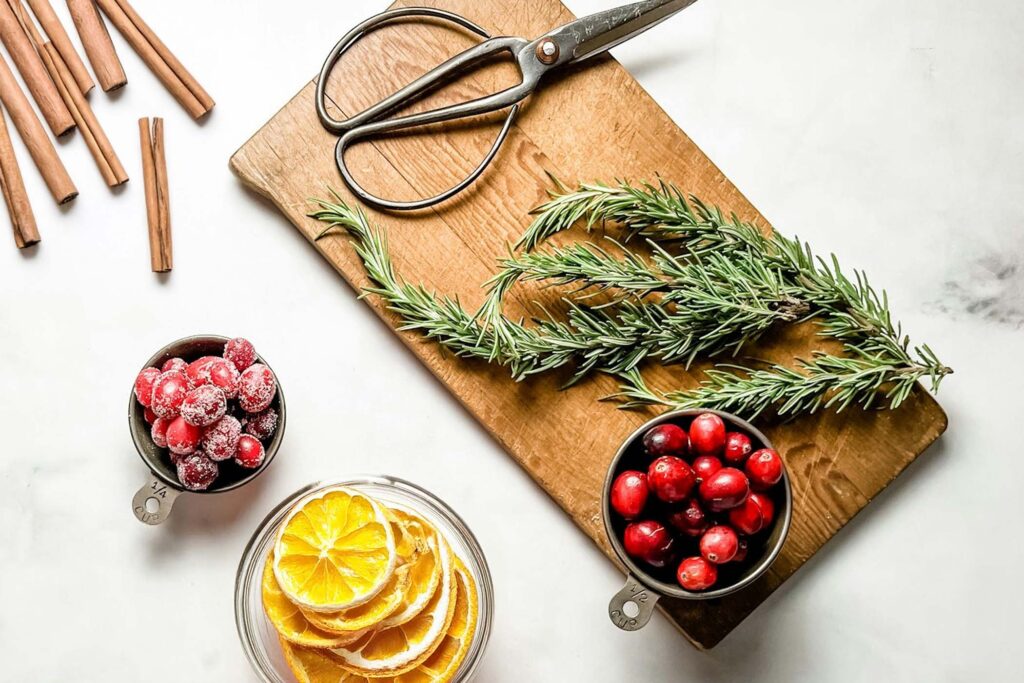 ingredients for cranberry potpourri on a cutting board and marble counter