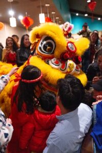 People greeting lion dancers