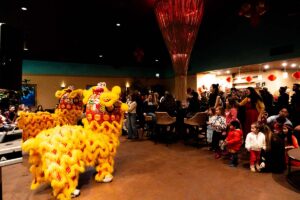 Lions performing for crowd inside tasting room