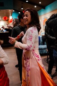 Woman wearing traditional dress at Lunar New Year party